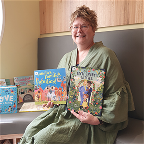 Youth librarian Bronwyn holding two picture books