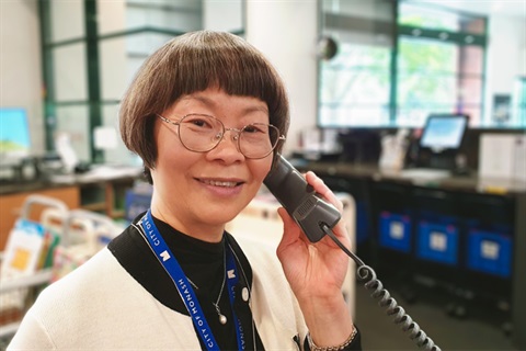 a photo of a library staff member answering the phone