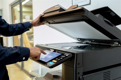 a person using a photocopier