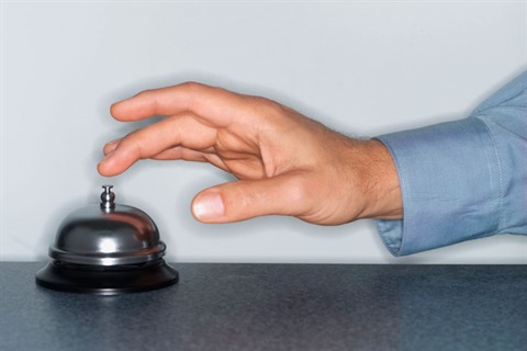 person ringing service bell