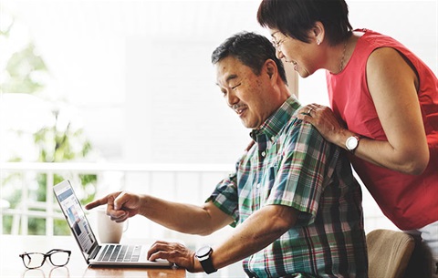 elderley-senior-couple looking at computer