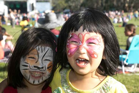 Kids with faces painted at Carols by Candlelight