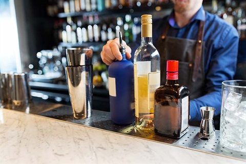 Barman with shaker at bar