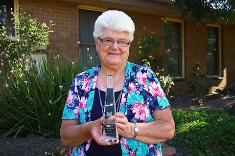 Bernadette Allan photographed with award