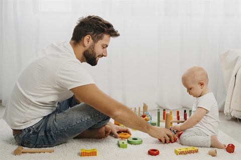 Father and baby playing with toys