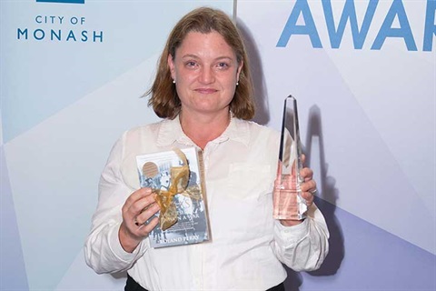 Phoebe Moore photographed with award