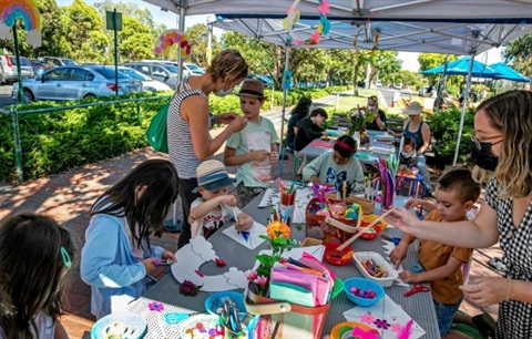Children painting and crafting at a shared table