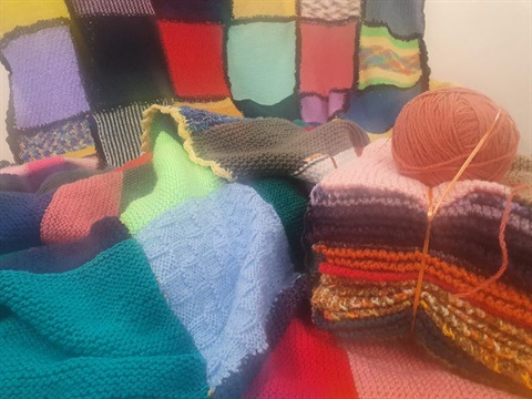 brightly coloured woollen blankets knitted by community care project