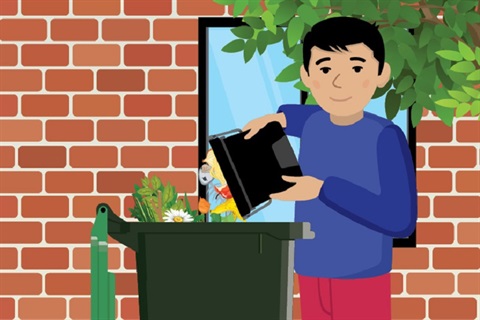 Person putting items in a food and garden waste bin