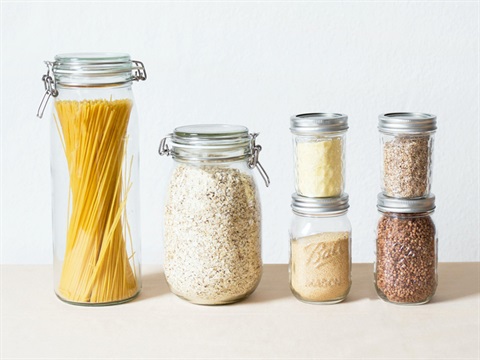 Glass jars with pasta and other food items