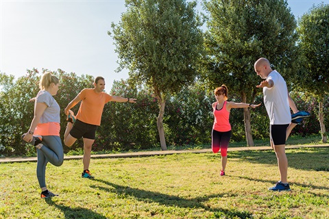 group-people-stretching-their-legs-private-training-session-urban-park.jpg